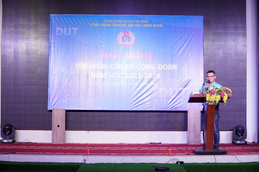 A person standing at a podium
Description automatically generated