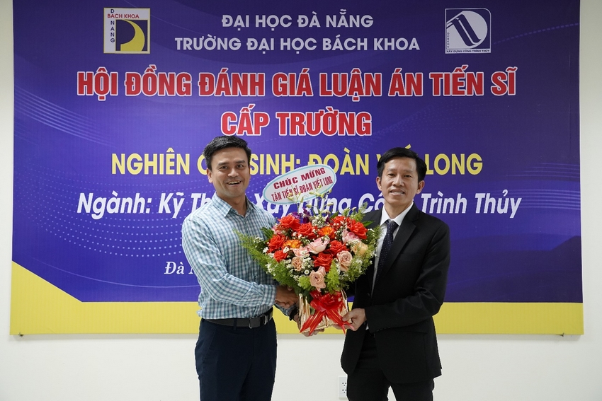 Two men holding flowers and posing for a picture

Description automatically generated