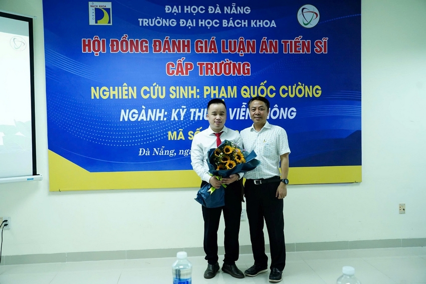 Two men standing in front of a sign

AI-generated content may be incorrect.