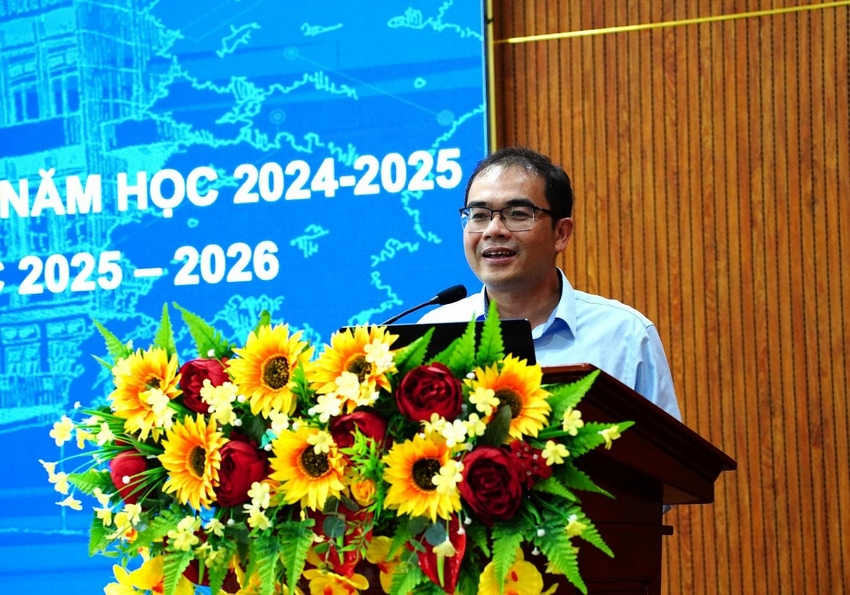 A person standing at a podium with a microphone and flowers

AI-generated content may be incorrect.