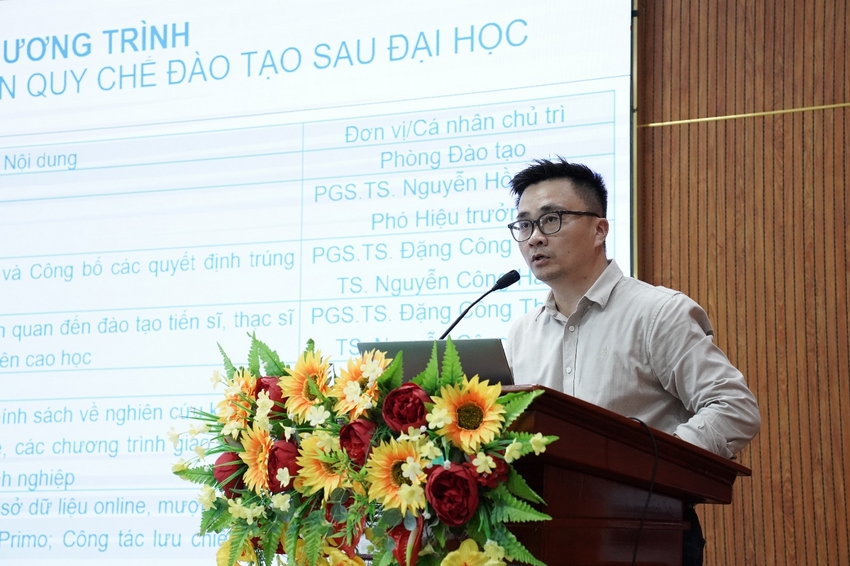 A person standing at a podium with a microphone

AI-generated content may be incorrect.