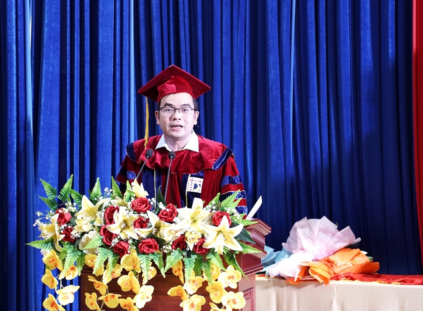 A person in a graduation gown and cap standing at a podium

AI-generated content may be incorrect.