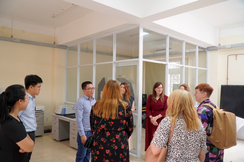 A group of people standing in a room

Description automatically generated