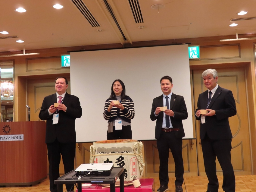 A group of people standing in front of a white screen

AI-generated content may be incorrect.