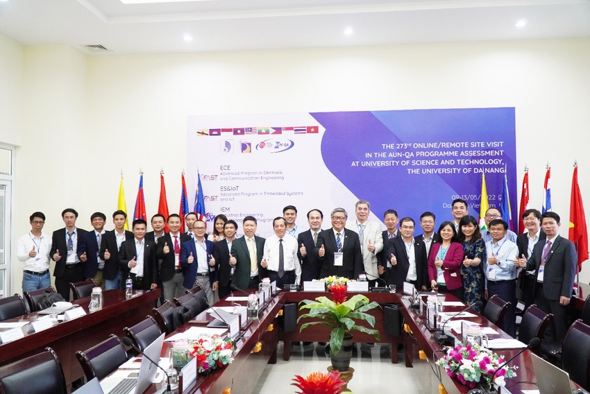 A group of people standing in a room with flags
Description automatically generated with low confidence