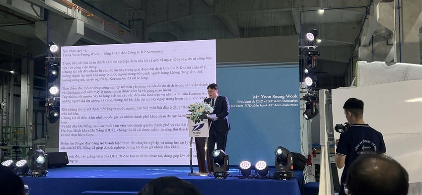 A person standing on a podium with a bouquet of flowers

AI-generated content may be incorrect.