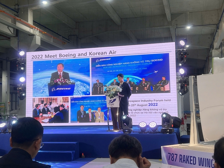 A person standing on a stage with a large screen

AI-generated content may be incorrect.