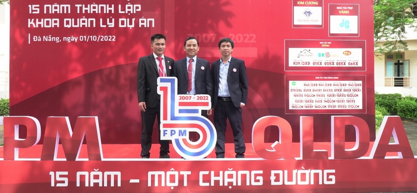 A group of men standing in front of a sign
Description automatically generated with medium confidence