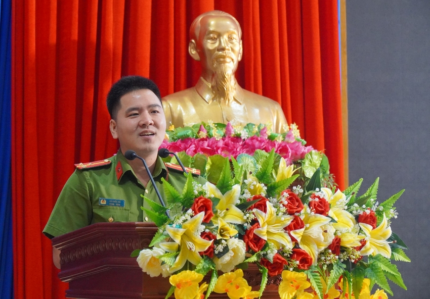 A person in uniform standing behind a podium with flowers

Description automatically generated