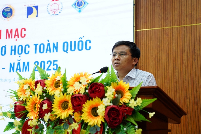 A person standing at a podium with a microphone and flowers

AI-generated content may be incorrect.