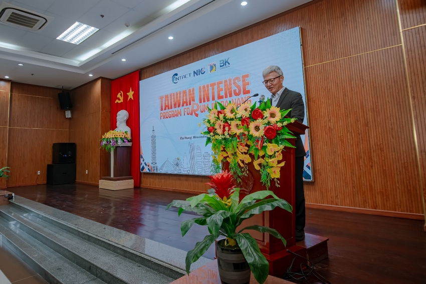 A person standing at a podium with flowers on it

AI-generated content may be incorrect.