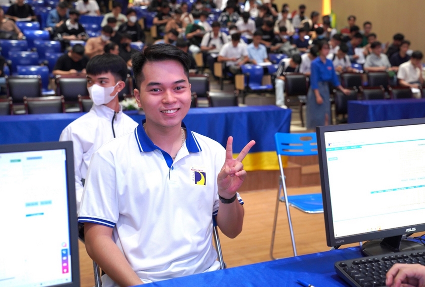 A person sitting at a desk with a couple of computer monitors

Description automatically generated